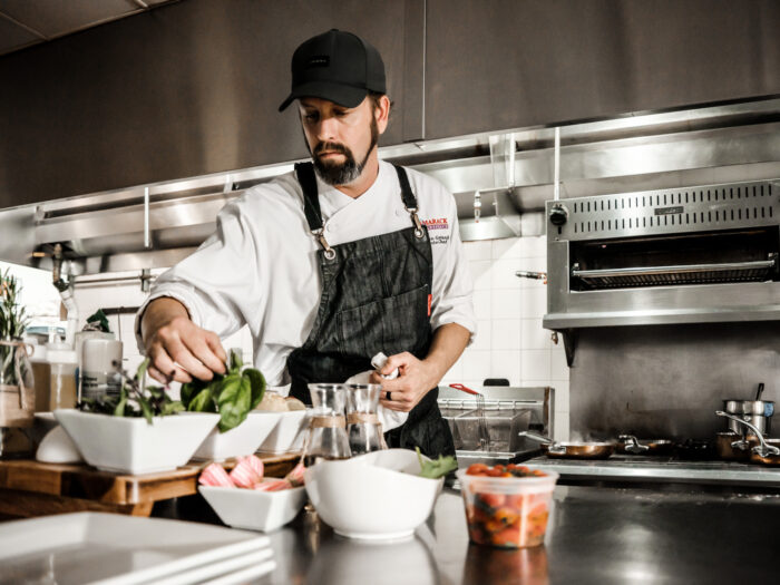 A chef gathering ingredients and cooking a meal 