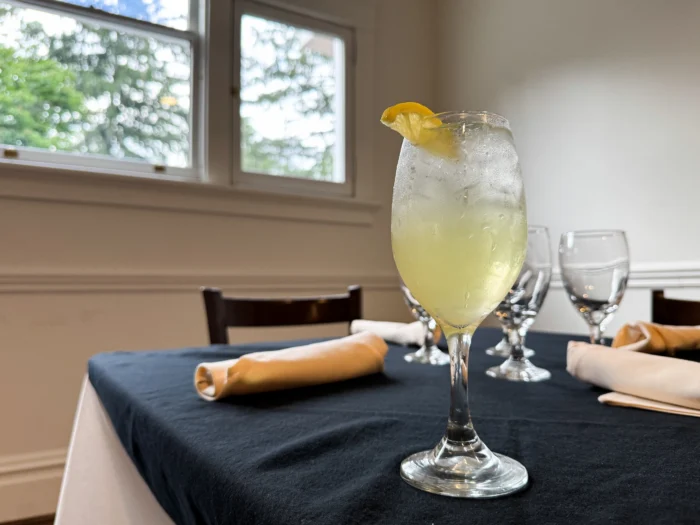 a cocktail stands on a set table in the sun, The Gaines Estate