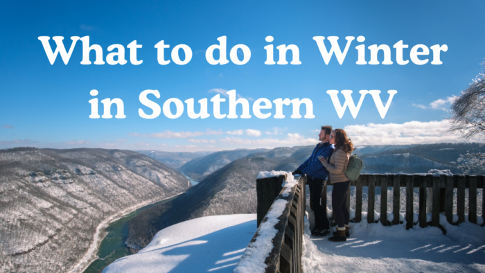 A couple stands on a snow covered wooden deck overlook the mountains and a river in the valley with the text "What to do in Winter in Southern WV" visible