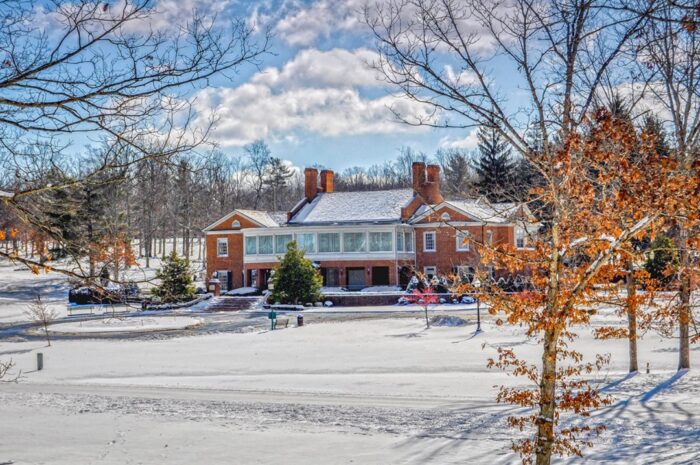 Snowy photo of The Resort at Glade Springs. Snow covered ground and house paint a cozy inviting space.