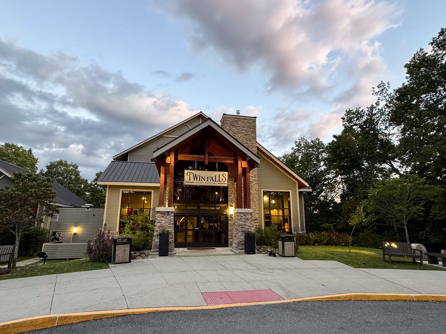 Lodge building surrounded by trees at sunset