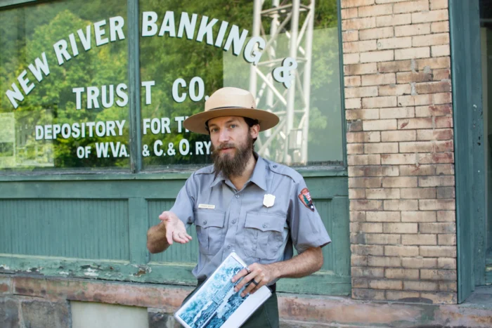 National Park ranger gesturing toward the camera and audience