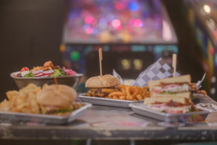 Burgers, sandwiches, fries, salad on table
